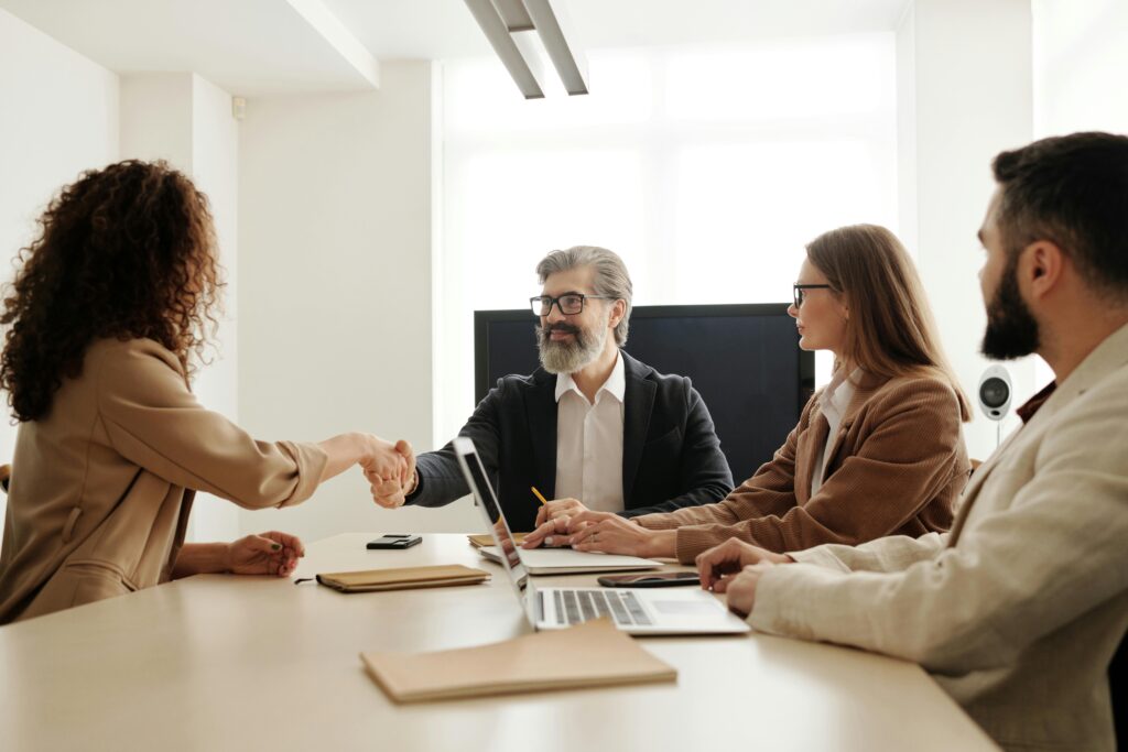 business team members meeting with a client while discussing questions to ask when selling a business