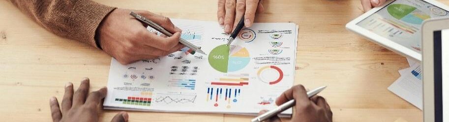 A group of people discussing a graph AI-generated content may be incorrect.