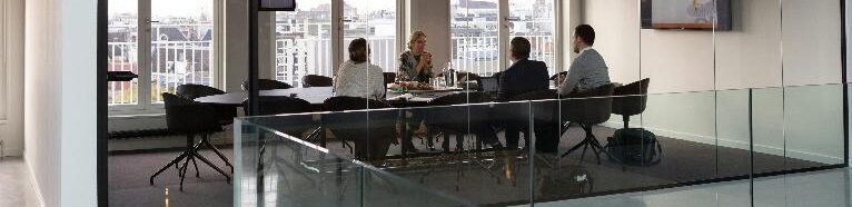 Modern office conference  room with professionals engaged in a collaborative business meeting , symbolizing discussion of how much a business can sell for