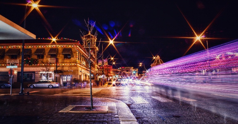 Kansas City street lit at night with local shops indicating potential owners seeking knowledge on how to sell a small business