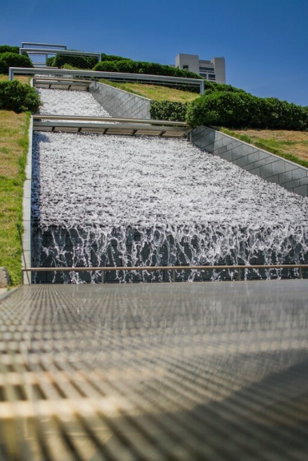The tiered stone waterfall at McGovern Centennial Gardens in Hermann Park, representing the effects of experience in how to sell a small business in Houston.