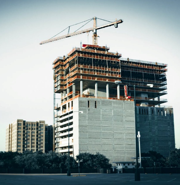  A high-rise building under construction in downtown Houston, representing growth and the strategic process of how to sell a small business in Houston. 