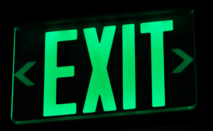 Close-up of a glowing exit sign, symbolically representing the strategic timeline for family business exit planning.